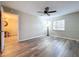 Bedroom with wood-look floors, ceiling fan, and view of dining area at 4507 S Oak Dr # P71, Tampa, FL 33611