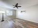 Bedroom with large window, ceiling fan, and wood-look floors at 4507 S Oak Dr # P71, Tampa, FL 33611