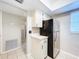 Compact kitchen with stainless steel refrigerator and white cabinets at 4507 S Oak Dr # P71, Tampa, FL 33611