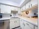 Condo kitchen with white cabinets, stainless steel appliances, and breakfast bar at 4507 S Oak Dr # P71, Tampa, FL 33611