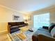 Living room with two sofas, coffee table, and access to patio at 4507 S Oak Dr # P71, Tampa, FL 33611