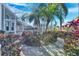 Landscaped backyard with tropical plants and brick path at 5606 Seagrass Pl, Apollo Beach, FL 33572