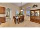 Well lit dining room with wooden table and chairs near kitchen at 5606 Seagrass Pl, Apollo Beach, FL 33572