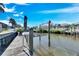 Private wooden dock with boat lift, offering water access at 5606 Seagrass Pl, Apollo Beach, FL 33572