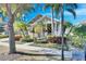 Inviting single-story house featuring a covered porch, beautiful landscaping, and a peaceful neighborhood setting at 5606 Seagrass Pl, Apollo Beach, FL 33572