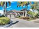Attractive single-level home with a two-car garage, neatly trimmed shrubs, and a well-kept front yard at 5606 Seagrass Pl, Apollo Beach, FL 33572
