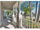 Covered porch with white columns and view of a lush, tropical neighborhood at 5606 Seagrass Pl, Apollo Beach, FL 33572