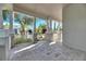 Spacious front porch with tile flooring and white railings, offering a relaxing outdoor space at 5606 Seagrass Pl, Apollo Beach, FL 33572