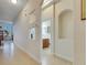 Bright hallway with neutral walls and tiled floor, plus views of additional rooms at 5606 Seagrass Pl, Apollo Beach, FL 33572