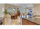 Open concept kitchen and dining area with stainless steel appliances and wood cabinetry at 5606 Seagrass Pl, Apollo Beach, FL 33572