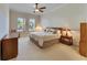 Large main bedroom with king-size bed and ceiling fan at 5606 Seagrass Pl, Apollo Beach, FL 33572
