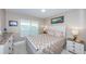 Bedroom with a light-colored dresser, nightstand, and bedding at 5901 Bahia Del Mar Cir # 321, St Petersburg, FL 33715