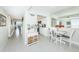 Bright dining area with white table and chairs, view of kitchen at 5901 Bahia Del Mar Cir # 321, St Petersburg, FL 33715