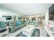 Spacious living room with light flooring and view into kitchen at 5901 Bahia Del Mar Cir # 321, St Petersburg, FL 33715