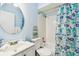 Clean bathroom with a tub and floral shower curtain at 601 N Hercules Ave # 1003, Clearwater, FL 33765