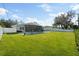 Large backyard with grassy area and a sunroom at 638 Mehlenbacher Rd, Belleair, FL 33756
