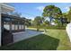 Spacious backyard with large grassy area and sunroom at 638 Mehlenbacher Rd, Belleair, FL 33756