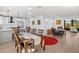 Bright dining area features a wooden table and chairs, adjacent to an updated kitchen at 638 Mehlenbacher Rd, Belleair, FL 33756