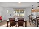 Charming dining area with a wood table, four chairs and a view to the kitchen at 638 Mehlenbacher Rd, Belleair, FL 33756