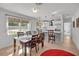 Spacious dining area with kitchen views, hardwood floors, and wood table at 638 Mehlenbacher Rd, Belleair, FL 33756