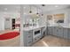 Modern kitchen with gray cabinets, white countertops, and stainless steel appliances at 638 Mehlenbacher Rd, Belleair, FL 33756
