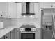 Modern kitchen with stainless steel appliances and white cabinets at 638 Mehlenbacher Rd, Belleair, FL 33756