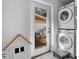 Laundry room with stackable washer and dryer and backyard access at 638 Mehlenbacher Rd, Belleair, FL 33756