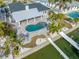 An aerial view of a waterfront home with a pool and private dock at 65 Dolphin Dr, Treasure Island, FL 33706