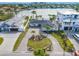 An aerial view of a waterfront home with a paved driveway at 65 Dolphin Dr, Treasure Island, FL 33706
