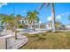 Landscaped backyard with pool, patio, and water access at 65 Dolphin Dr, Treasure Island, FL 33706