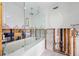Bathroom under renovation with new bathtub and glass enclosure at 65 Dolphin Dr, Treasure Island, FL 33706