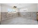 Unfinished bedroom with new tile flooring and exposed walls at 65 Dolphin Dr, Treasure Island, FL 33706