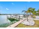 Private boat dock on calm water, near palm trees at 65 Dolphin Dr, Treasure Island, FL 33706