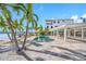 A kidney-shaped pool with a large patio and palm trees at 65 Dolphin Dr, Treasure Island, FL 33706