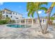 Inviting kidney-shaped pool with expansive paved patio at 65 Dolphin Dr, Treasure Island, FL 33706