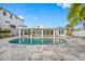 Inviting kidney-shaped pool with expansive patio at 65 Dolphin Dr, Treasure Island, FL 33706