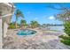 Enjoy waterfront views from this kidney-shaped pool at 65 Dolphin Dr, Treasure Island, FL 33706