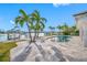 Inviting kidney-shaped pool with patio and waterfront view at 65 Dolphin Dr, Treasure Island, FL 33706