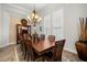 Elegant dining room features a large wood table, chandelier, and built-in hutch at 1113 Merry Water Dr, Lutz, FL 33548