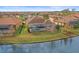 House near the lake with a pool and lush green backyard at 11910 Climbing Fern Ave, Riverview, FL 33579
