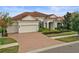 Single-Gathering home with a brick driveway and a well-manicured lawn at 11910 Climbing Fern Ave, Riverview, FL 33579