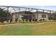 Landscaped backyard with pool and screened enclosure at 11910 Climbing Fern Ave, Riverview, FL 33579