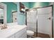 Modern bathroom with white tile shower and white vanity at 11910 Climbing Fern Ave, Riverview, FL 33579