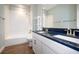 Bathroom with a double vanity, shower, and dark countertop at 11910 Climbing Fern Ave, Riverview, FL 33579