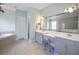Elegant bathroom with double vanity, large mirror, and walk-in shower at 11910 Climbing Fern Ave, Riverview, FL 33579