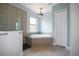 Spa-like bathroom with soaking tub, walk-in shower, and tile flooring at 11910 Climbing Fern Ave, Riverview, FL 33579