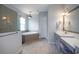 Large bathroom with double vanity, soaking tub and shower at 11910 Climbing Fern Ave, Riverview, FL 33579