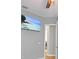 Bright bedroom with mounted TV and access to laundry room at 11910 Climbing Fern Ave, Riverview, FL 33579