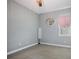 Bedroom with gray walls, carpeted floors, and window with plantation shutters at 11910 Climbing Fern Ave, Riverview, FL 33579