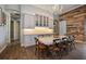 Bright dining room with farmhouse table and chairs, adjacent to kitchen at 11910 Climbing Fern Ave, Riverview, FL 33579